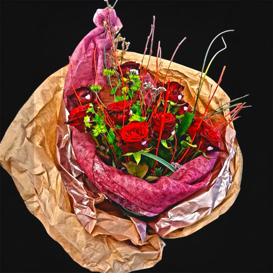 A Valentine’s bouquet built around deep red roses.